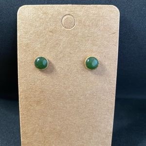 Tiny green glass dot earrings with gold tone trim.